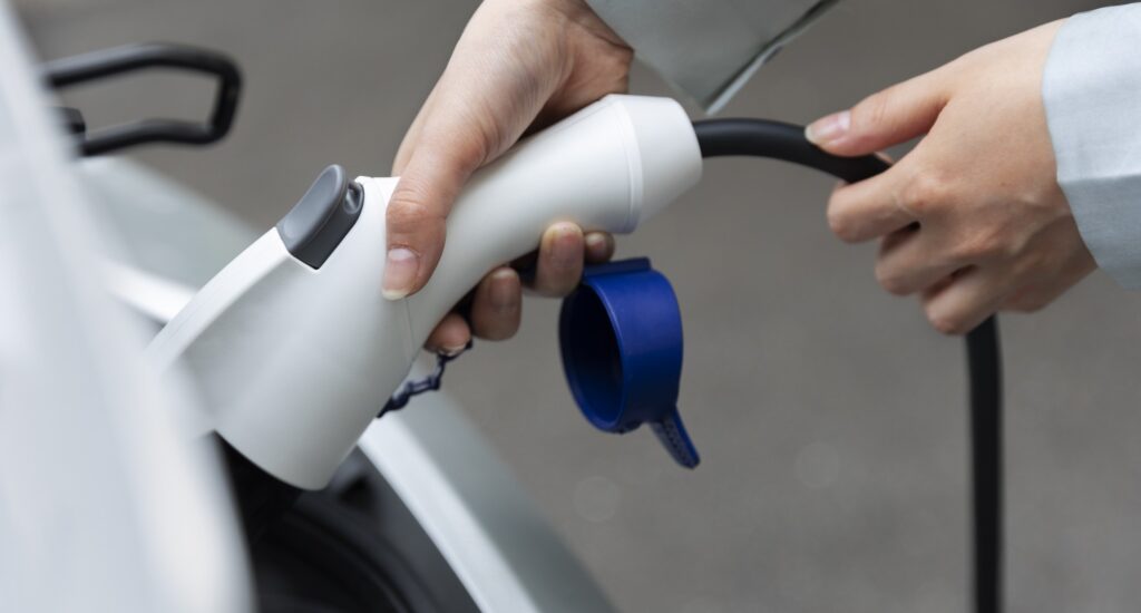woman charging her electric car station
